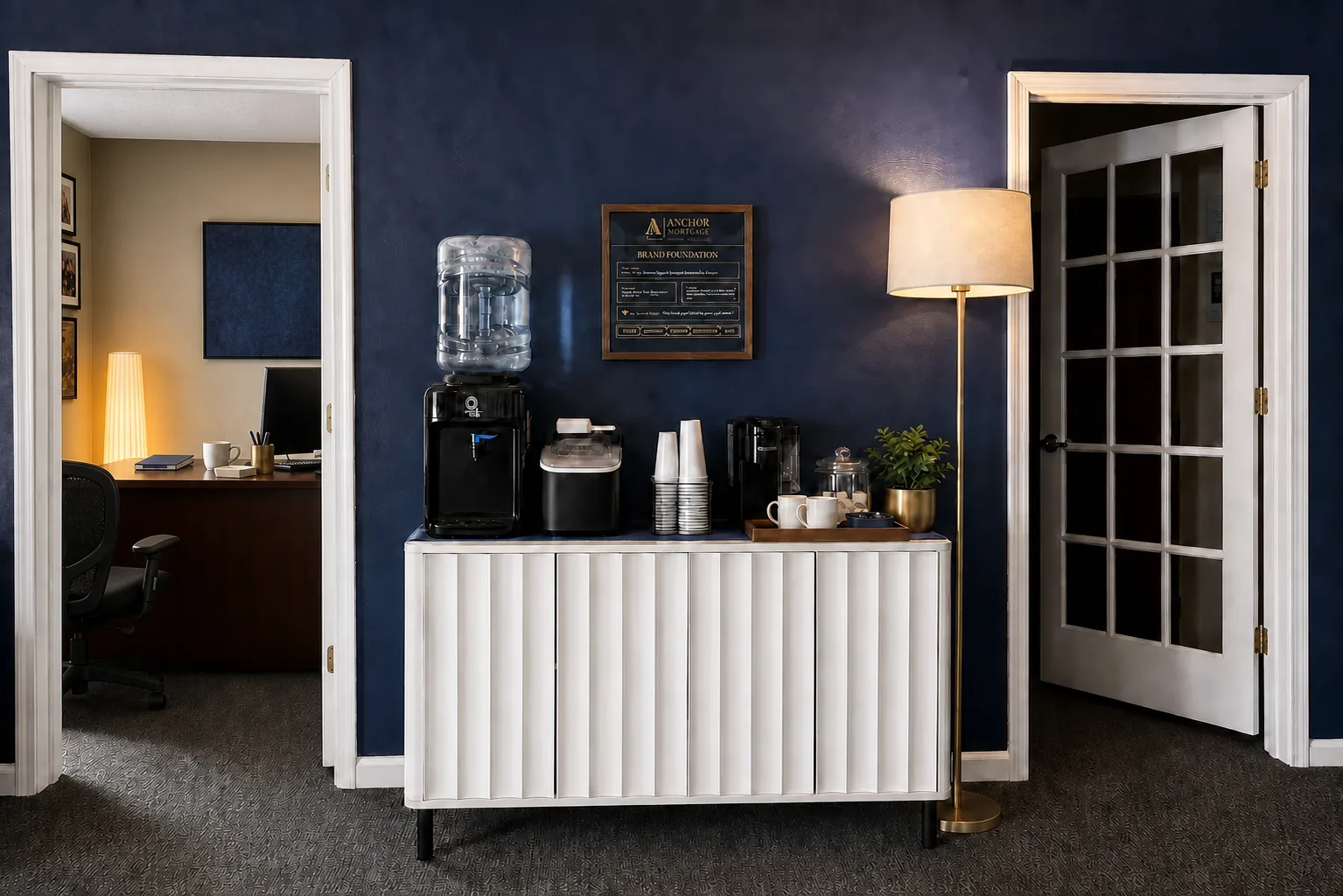 Anchor coffee station and brand foundation beside John's gallery-wall office
