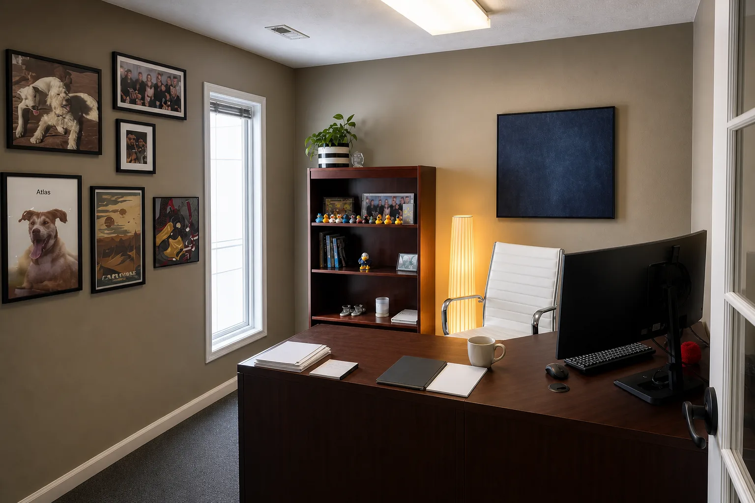 John's working desk with a personal gallery wall in the Anchor Mortgage office